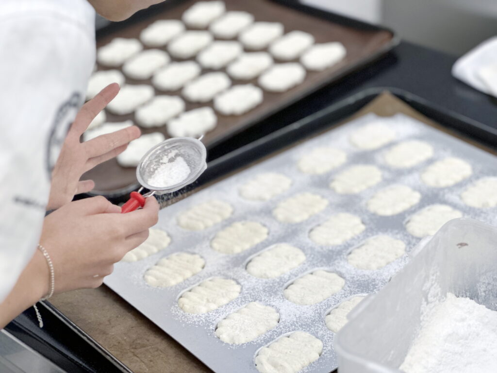 5 베이킹클래스-틀에 반죽을 다 붓고 그 위에 가루를 뿌려주는 모습